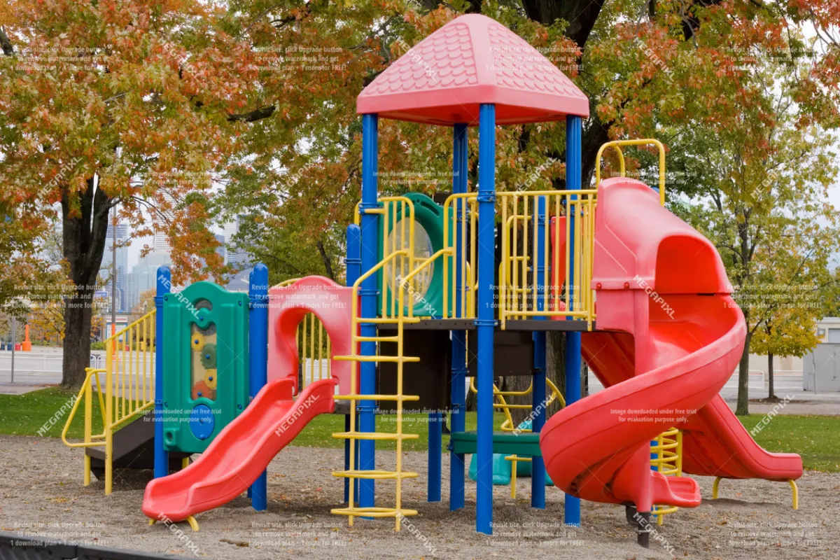 A colorful playground filled with slides and climbing structures, bustling with children at play. The vibrant equipment and lively activity create an atmosphere of fun and excitement.